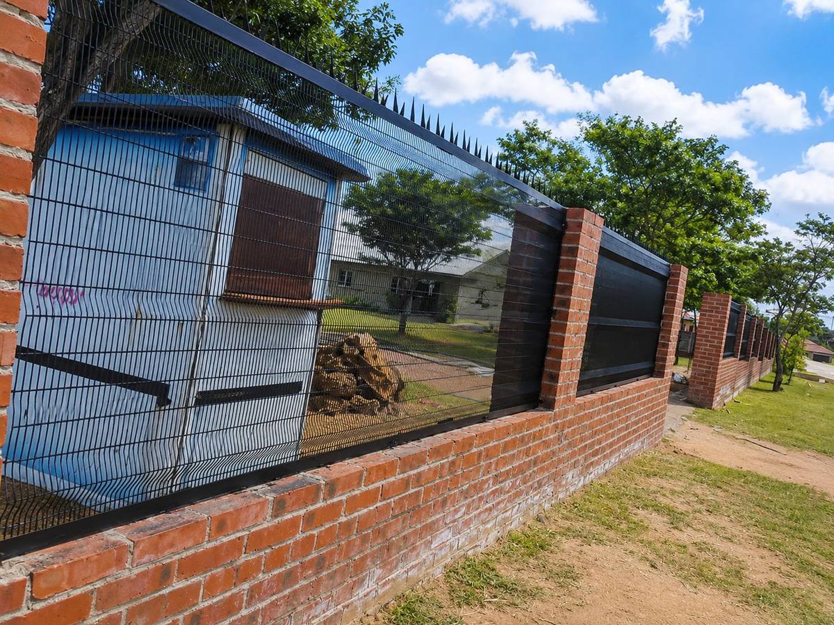 Clear view anti-climb fence panels on a brick wall